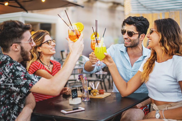 group of young friends toasting with mocktails